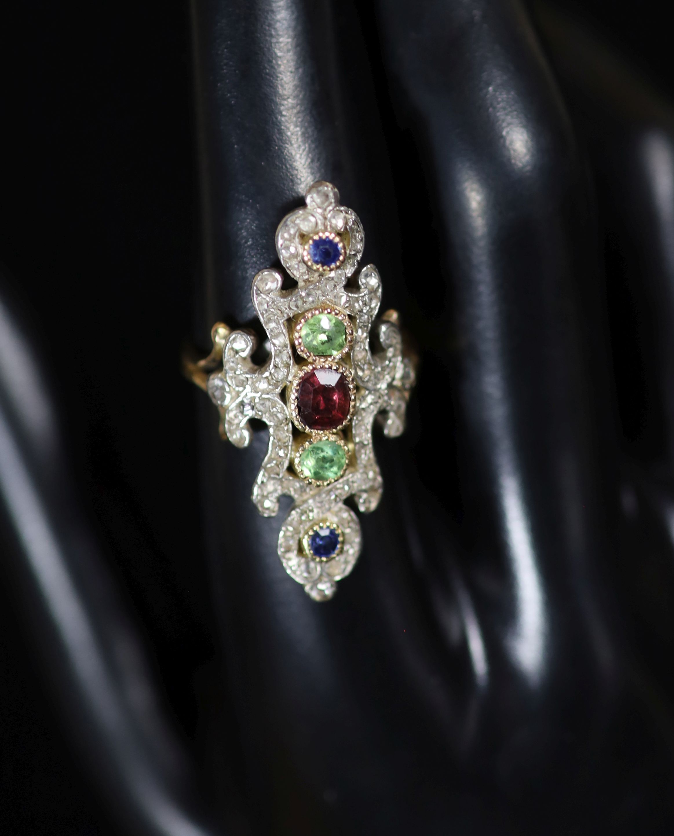 A 20th century ornate gold, garnet, peridot, sapphire and diamond chip set up-finger dress ring